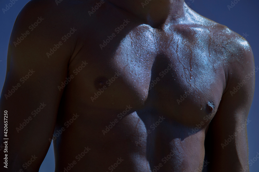 © Sonja Lekovic/Stocksy - sweaty fit male body detail