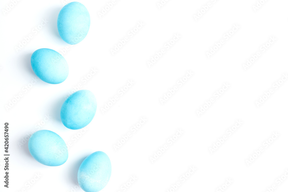 Happy Easter concept. Chicken eggs painted in blue color in the egg compartment. Preparation for holiday. White background copy space Happy Easter concept. Chicken eggs painted in blue color in the egg compartment. Preparation for holiday. White background copy space