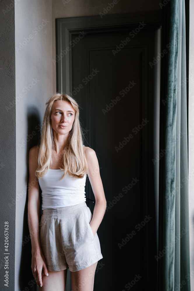 Woman in pajama resting in hallway Woman in pajama resting in hallway