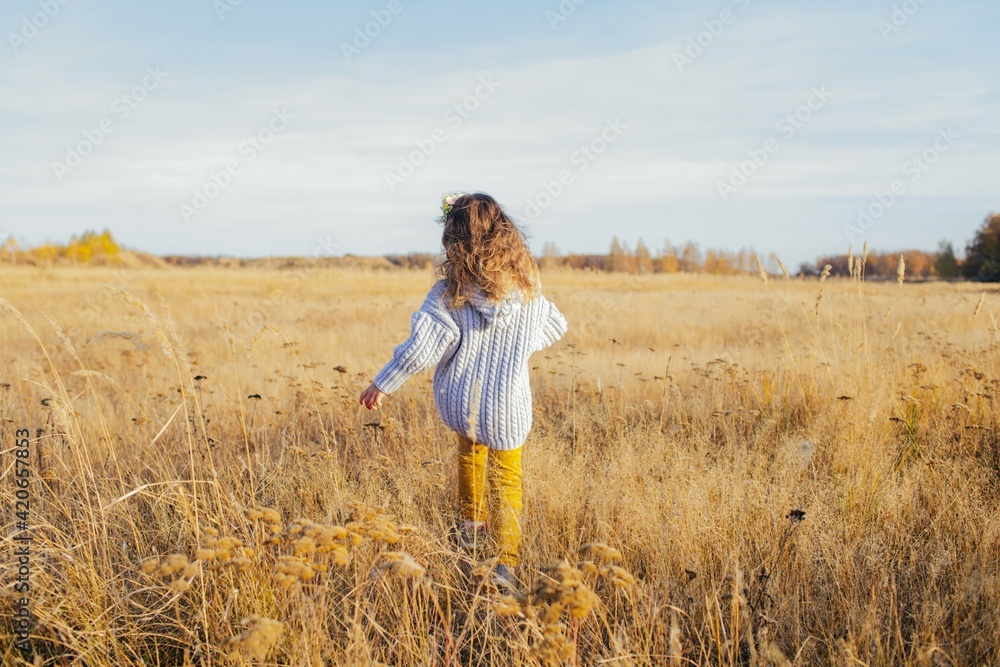 Cute little girl running by the field Cute little girl running by the field