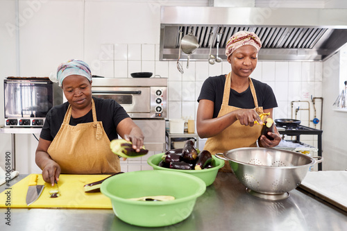 Women preparing food in a catering kitchen photo