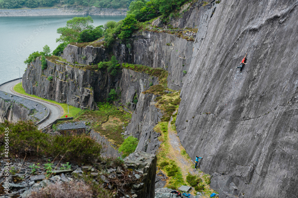 Climber climbing at stuning walls of the ancient Dinorwic Quarry at
