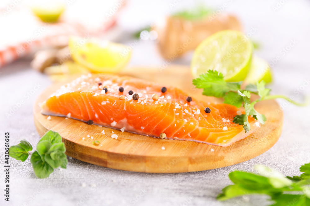 raw salmon on board with lemon and herbs