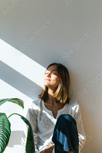 Young woman relaxing in sunlight
