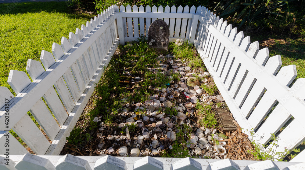 Grave inside a white picket fence
