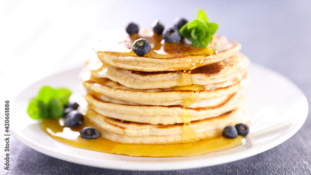 stack of pancake with pouring syrup stack of pancake with pouring syrup