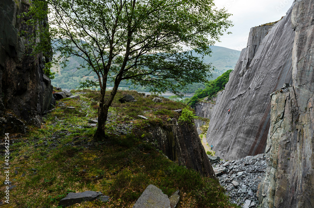 Climber balancing on slab wall in slate quarry Climber balancing on slab wall in slate quarry