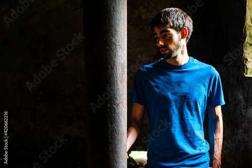 Tourist into to the walls of building in decay in quarry photo