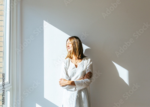 Portrait of a female standing in sunlight photo