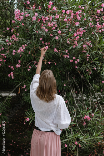Woman touching oleander flower photo