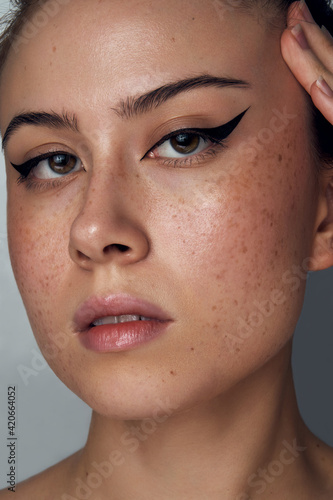 Beauty Portrait of a Woman With Freckles and Eyeliner photo