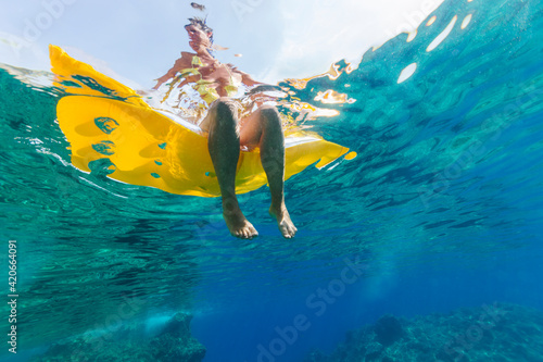 Woman relaxing on a lilo cooling her feet
