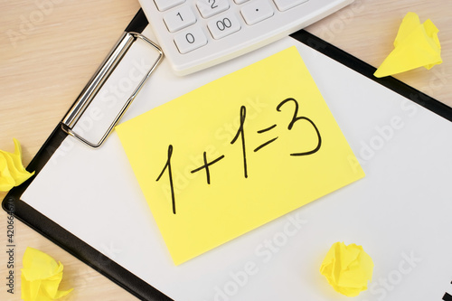 On the stationery board near a white calculator and yellow crumpled sheets of paper there is a sheet on which an example with an incorrect answer of the solution is written.