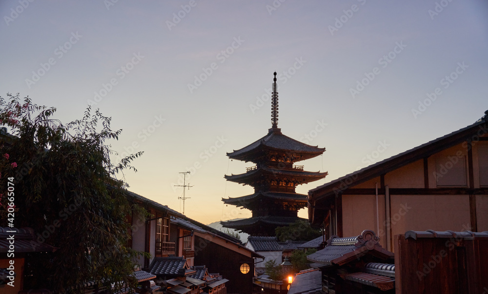 Traditional oriental pagoda in garden against sunset sky Traditional oriental pagoda in garden against sunset sky