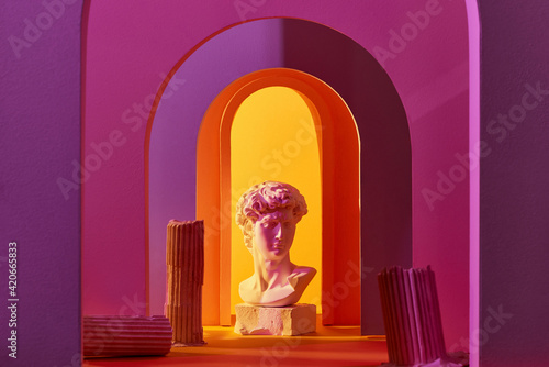 abstract composition of sculpture and primitive objects on colorful background