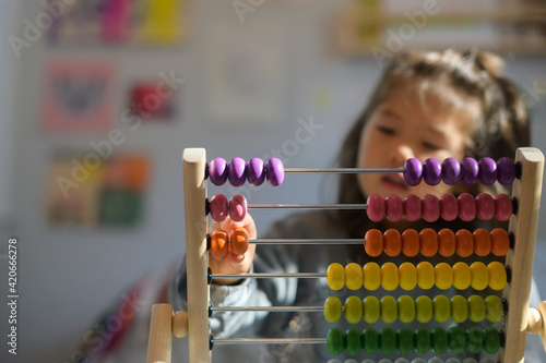 Child counting on abacus tool