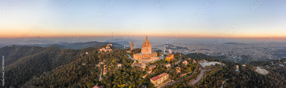 Aerial panorama drone view of Sacred Heart Basilica on top of Tibidabo near Barcelona during sunset in Spain winter