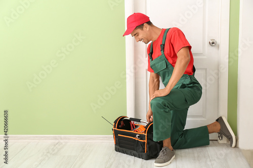 Worker with tools bag near ...