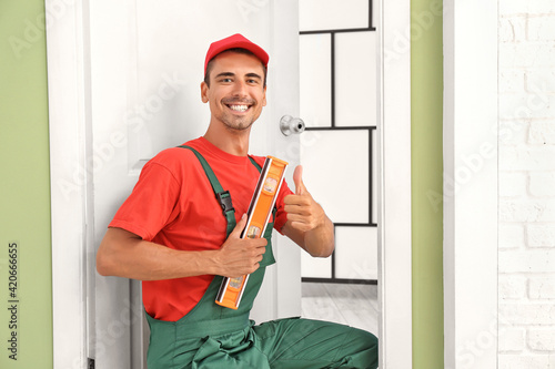 Worker with ruler level sho...