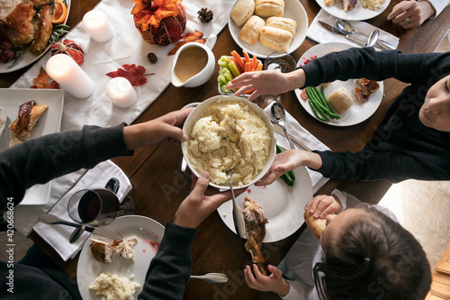 Thanksgiving: Mashed Potatoes Passed Across Table From Overhead photo