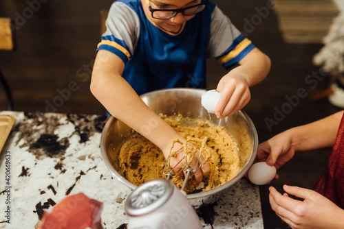 Brothers making chocolate chip cookies for the holidays.