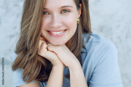 Beautiful smiling woman. Portrait of a young woman with regular features. High quality photo.