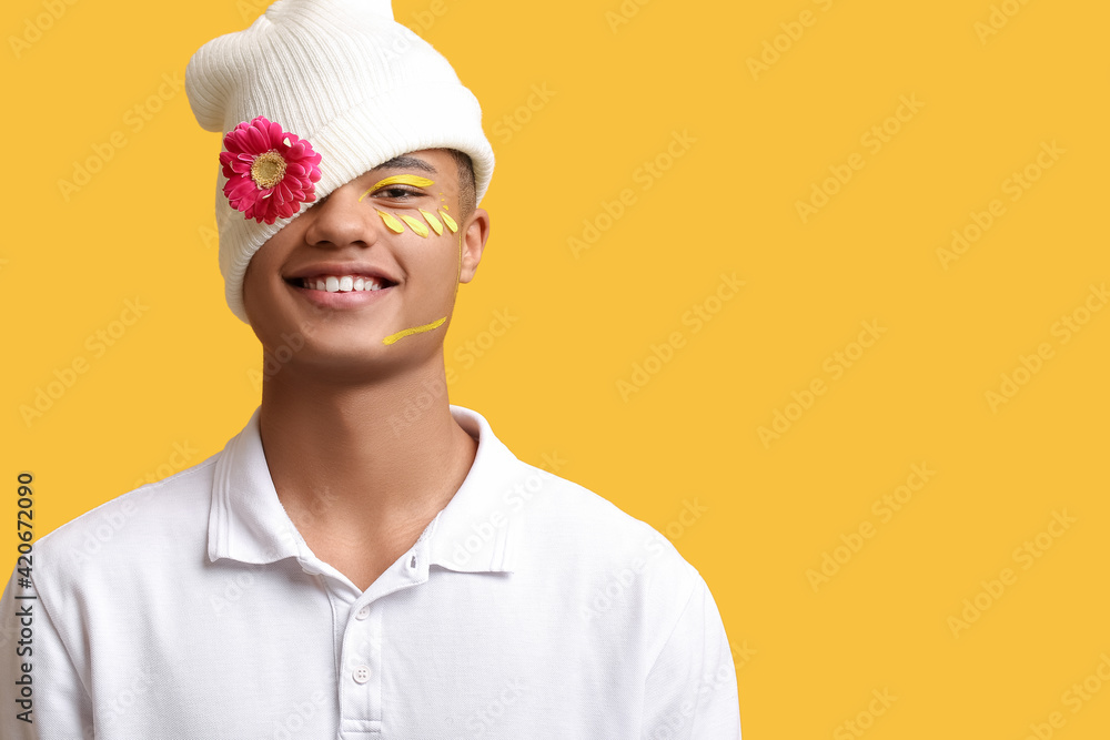 Creative portrait of handsome young man with flower on color background Creative portrait of handsome young man with flower on color background