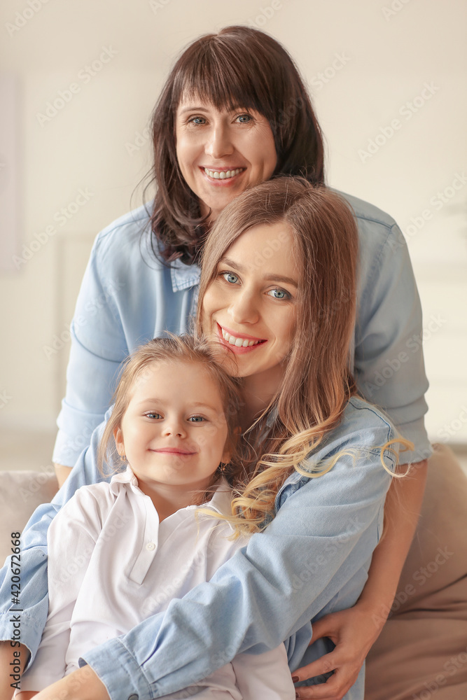 Young woman, her little daughter and mother at home Young woman, her little daughter and mother at home