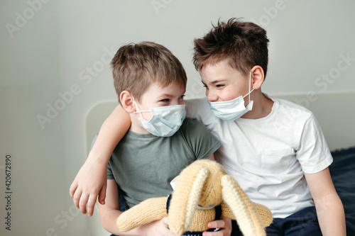 Young brothers in protective medical masks. photo