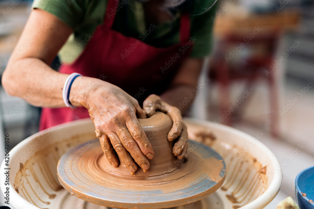 Woman Making Pottery On Spinning Wheel Woman Making Pottery On Spinning Wheel