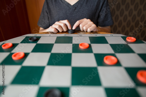 Child plays checkers photo