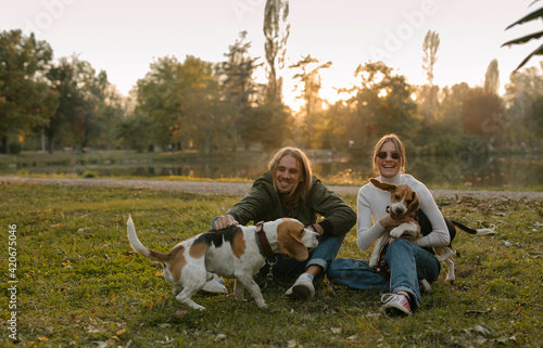 Young couple with their Beagle Dogs photo