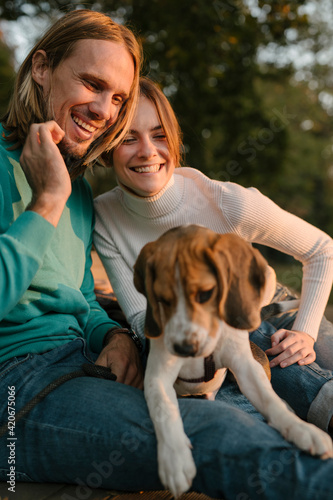 Couple Happily Plays With Pet Dogs photo