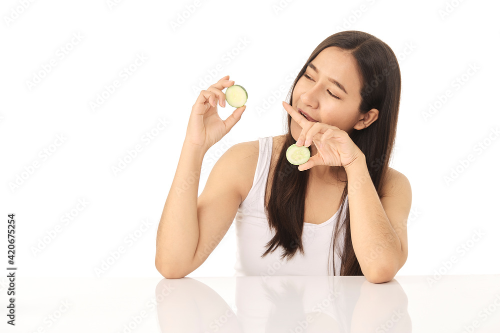 Beautiful young Asian woman cleaning beauty face, using cucumber slices cleansing lotion, and facial toner for removing makeup. A beautiful girl has nice facial skin Beautiful young Asian woman cleaning beauty face, using cucumber slices cleansing lotion, and facial toner for removing makeup. A beautiful girl has nice facial skin