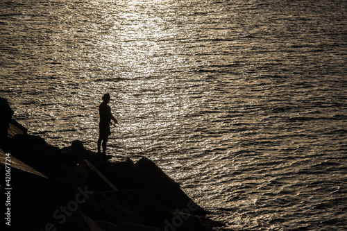 silhouette of fisherman photo