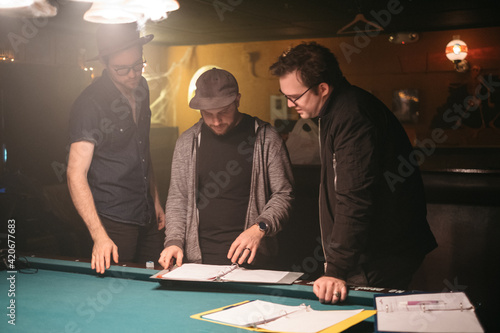 A film crew reviews a script before filming photo
