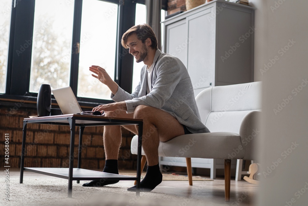 Male remote working from home and having work confrence video call.