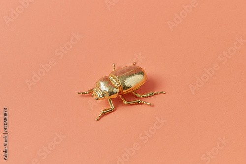 Metal scarab bug made from golden. photo