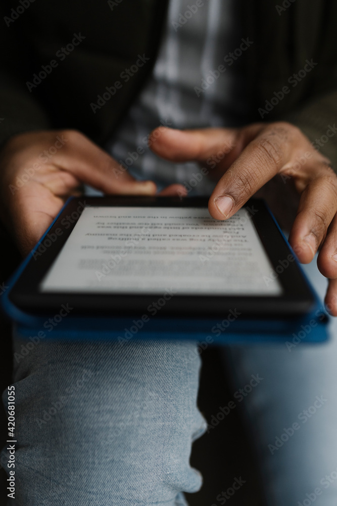 Black hands Holding an E-Book Tablet Black hands Holding an E-Book Tablet