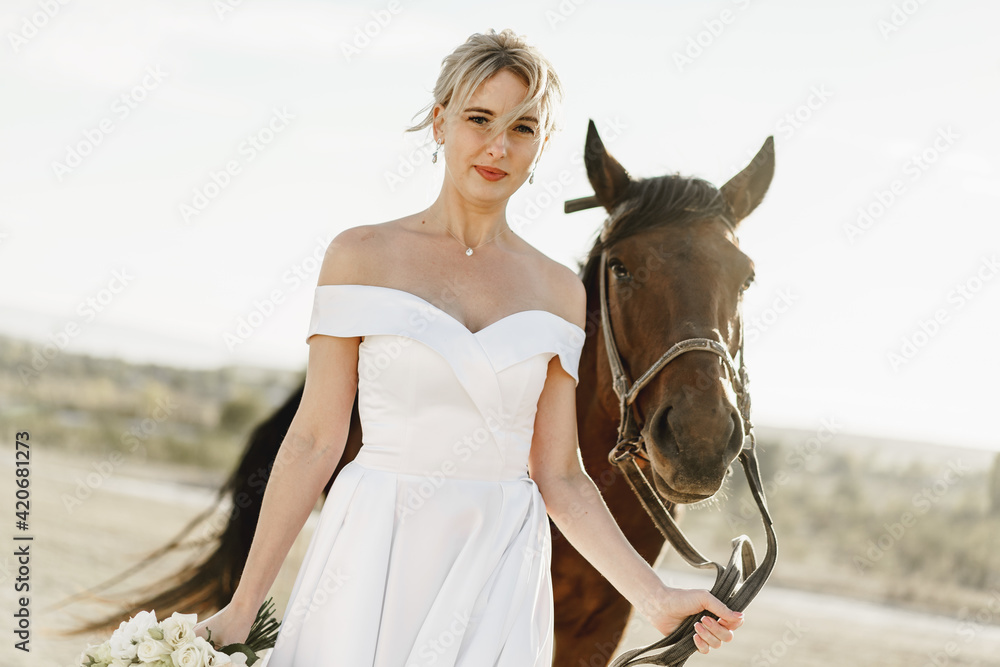 Obraz premium Portrait of a beautiful bride with horse