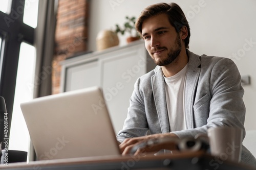 Male remote working from home and having work confrence video call.