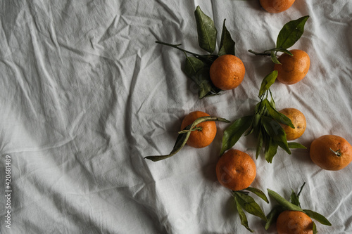 Wallpaper Mural Raw oranges, tangerines on crumpled cloth. Fresh healthy fruits, food background. Flatlay, top view. Torontodigital.ca