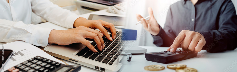 Healthcare costs and fees concept.Hand of smart doctor used a calculator for medical costs in modern hospital Healthcare costs and fees concept.Hand of smart doctor used a calculator for medical costs in modern hospital