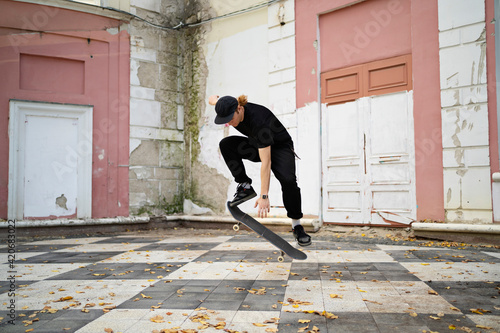 Skater doing trick in the city landscape photo