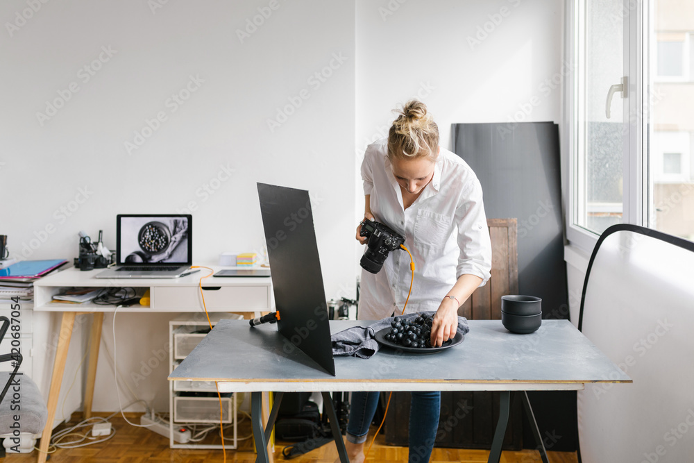 Female photographer working in a studio Female photographer working in a studio