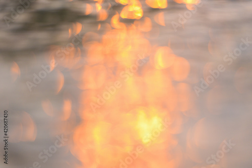 Abstract sunlight reflective on water background, Lights bokeh on water surface at sunset nature summer or spring ocean sea
