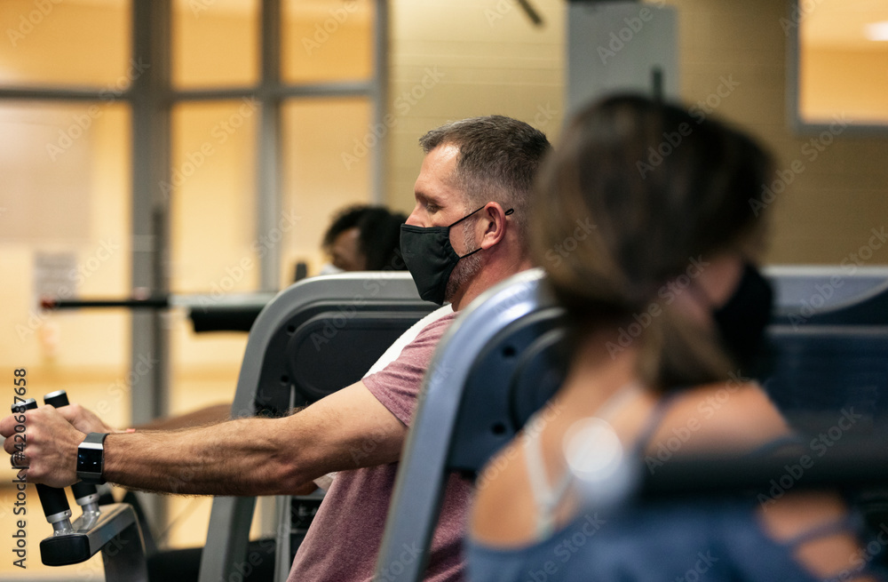 Gym: Man Wears Mask While Working Crunch Machine Gym: Man Wears Mask While Working Crunch Machine