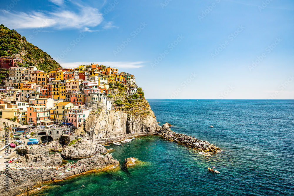 A colorful town on a cliff by the sea 
