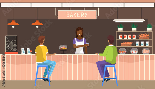 Friendly saleswoman working and selling fresh drink to customers. Modern bakery interior design