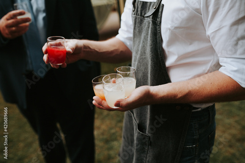 waiter serving different kind of drinks photo